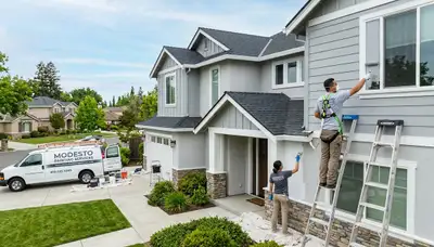 Professional house painter working on exterior home in Stockton, CA